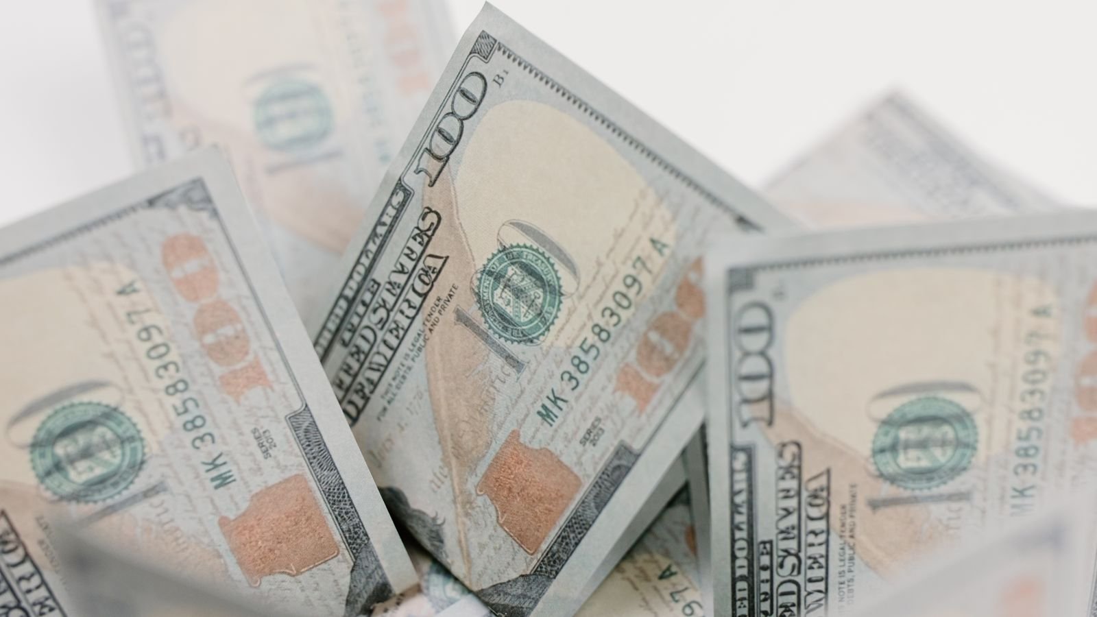 Close-up of US hundred dollar bills, representing embedded finance market growth and banking infrastructure investment